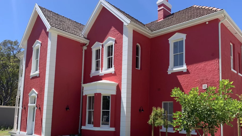 Photo of a Calgary home with freshly painted red stucco exterior