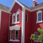 Photo of a Calgary home with freshly painted red stucco exterior